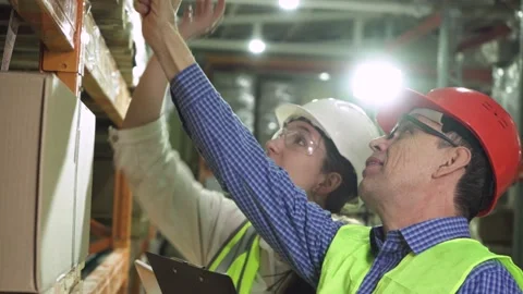 Young warehouse workers working together. Stock Footage 170778393