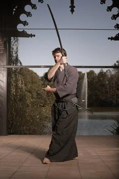 Young warrior practicing intense sword fighting techniques during training Stock Photos