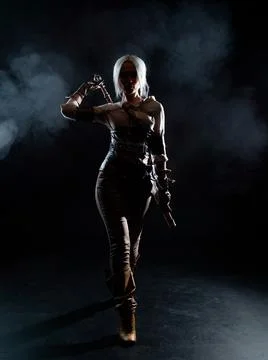 A young warrior with a sword on a dark background. Fantasy heroine Foto stock