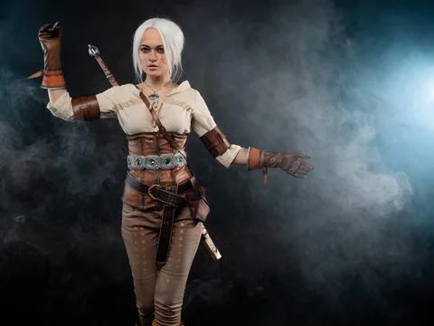 A young warrior with a sword on a dark background. Fantasy heroine Stock-Fotos