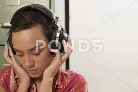 Young wearing headphones, eyes closed Stock Photos