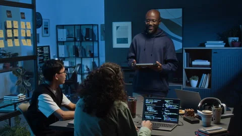 Young Web Engineer with Digital Tablet Speaking in Front of Two Gen Z Colleagues Stock Footage 329617455