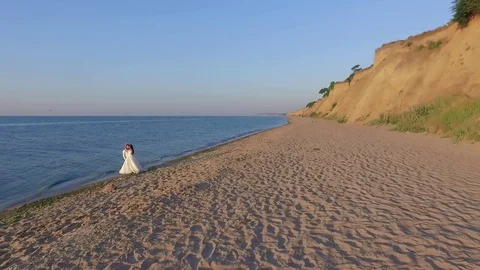 Young wedding couple bride and groom stand and hold hands in white wedding  Stock Footage 129624277