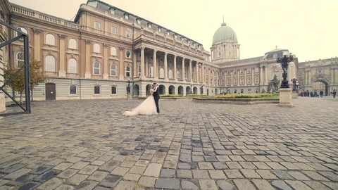 Young wedding couple, in the central square of the old town or castle Stock Footage 129559077