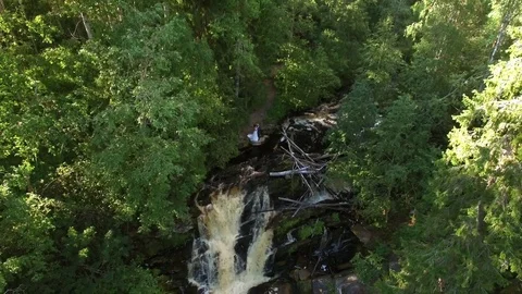 Young wedding couple staying near waterfall Stock Footage