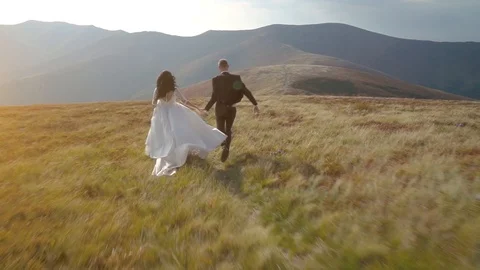 Young wedding couple walking in the mountains Stock Footage 89349596