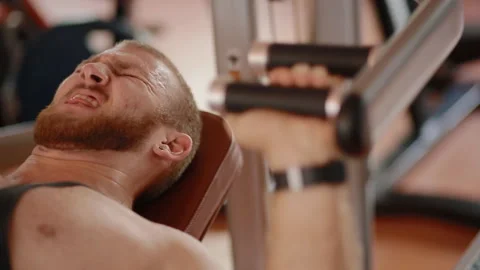 Young white bodybuilder making chest press in the simulator Stock Footage 102229055