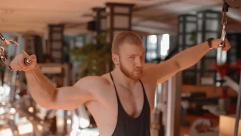 Young white bodybuilder making crossover pulley Stock Footage 102230515