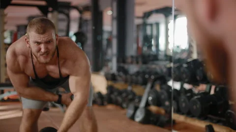 Young white bodybuilder training biceps in the gym Stock Footage 102232540