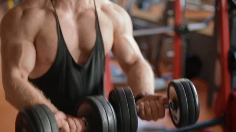 Young white bodybuilder training biceps in the gym Stock Footage 102232709