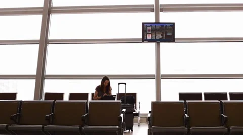 Young white caucasion checking laptop at Malaysian airport lounge Stock Footage 62902242