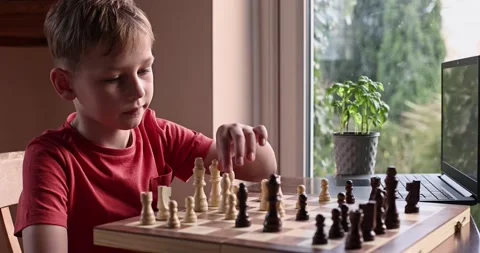 Young white child playing a game of chess on large chess board. Stock Footage 232773474