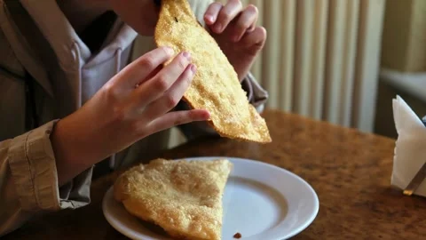 A young white girl eats a deep-fried patty. Stock Footage 282168489
