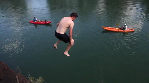 Young white guy jumping into river. Stock Footage 60912570