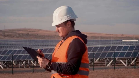 Young white man engineer checking solar panel at solar power plant Stock Footage 100751337