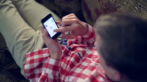 Young white man flips through the Internet on the smartphone iPhone Stock Footage 48595307