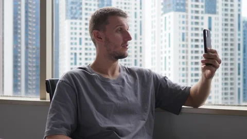 A young white manager in the office discussing his ideas with a remote colleague Stock Footage 158556973