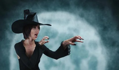 Young witch performs magic Stock Photos