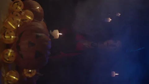 Young witch with skull and pumpkins Stock Footage 140859737