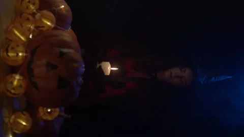 Young witch with skull and pumpkins Stock Footage 140860061