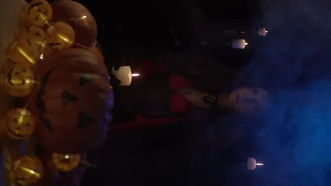 Young witch with skull and pumpkins Stock Footage 140860276