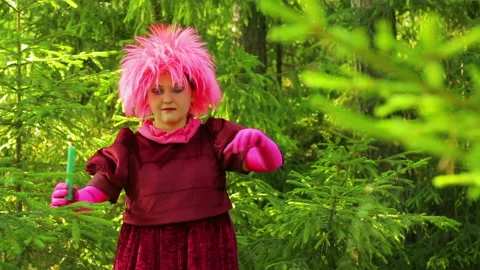 A young witch in a spruce forest performs ritual actions with his hands over a Stock Footage 94716565