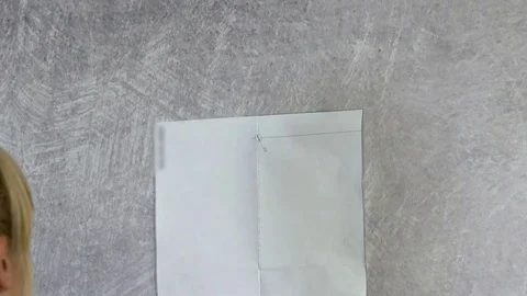 Young woman is about to attach a piece of paper with a screw Stock Footage