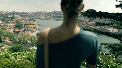 Young woman admire view of Porto standing on terrace in garden Stock Footage