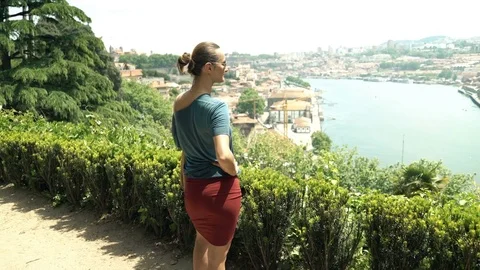 Young woman admire view of Porto standing on terrace in garden Stock Footage