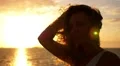 Young Woman Admiring the Sunset over Sea. Motivational and Inspiring Slow Motion HD Footage