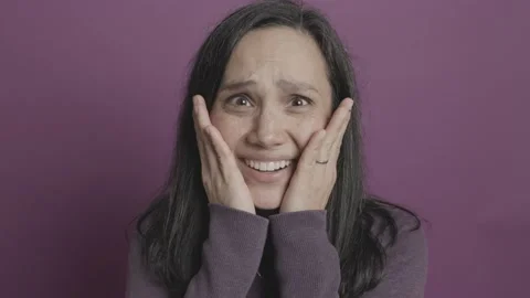 Young Woman Afraid While Holding Both Hands To Face Stockbeeldmateriaal 227751967