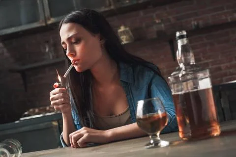 Young woman alcoholic smoker social problems concept sitting thoughtful Stock Photos