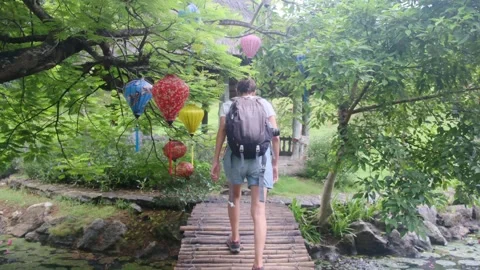 Young woman alone exploring walking on trail in tropical jungle Stock Footage 252036628