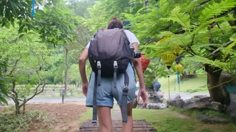 Young woman alone exploring walking on trail in tropical jungle Stock Footage 252036632