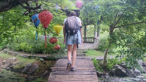 Young woman alone exploring walking on trail in tropical jungle Stock Footage 252036644