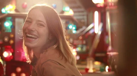 Young woman in amusement park, waving to the camera Stock Footage 59556270