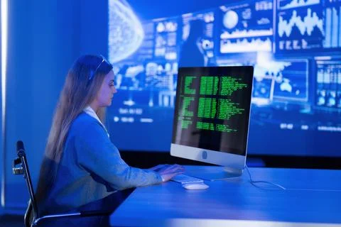 Young woman analyzes data on a computer screen in a modern office during la.. Foto stock