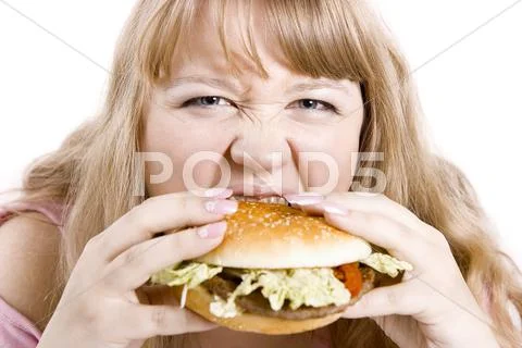 The young woman and hamburger Stock Photos