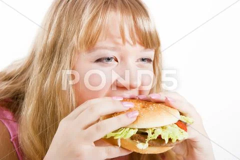 The young woman and hamburger Stock Photos