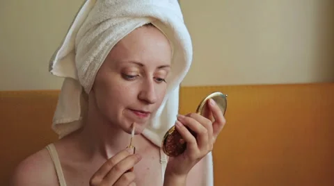 Young woman applies concealer foundation cream make up Stock Footage