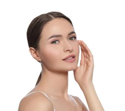 Young woman applying cream under eye on white background Stock Photos