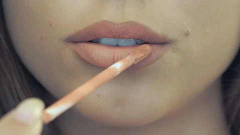 Young woman applying lip gloss - detail Stock Footage