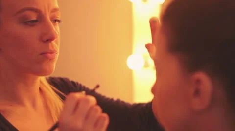 Young woman applying makeup Stock Footage