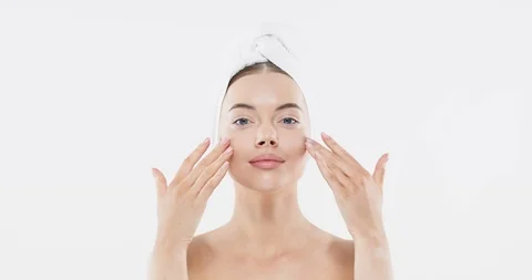 Young woman applying serum to face. Beautiful model girl with clean fresh skin Stock Footage