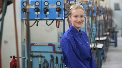 Young woman apprentice in metallurgy workshop Stock Footage 51565157