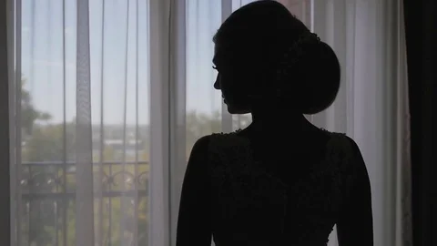 A young woman approaches the window, opens to a balcony, enjoying. morning bride Vidéo 81936741