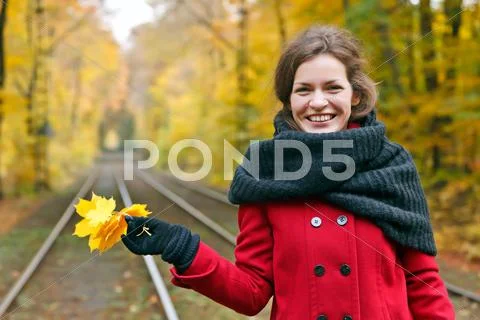 Young woman in autumn park Stock Photos
