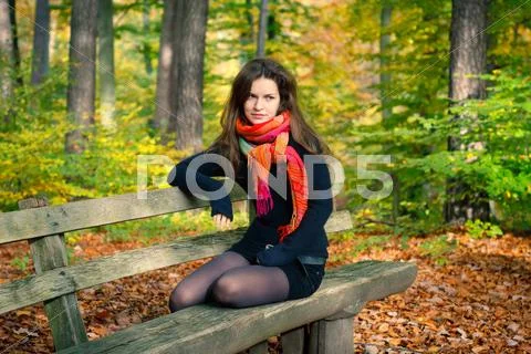 Young woman in autumn park Stock Photos
