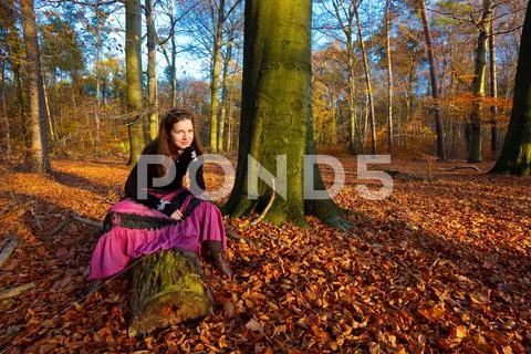 Young woman in autumn park Stock Photos