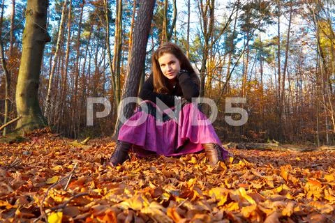 Young woman in autumn park Stock Photos
